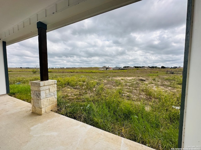 view of yard with a patio area and a rural view