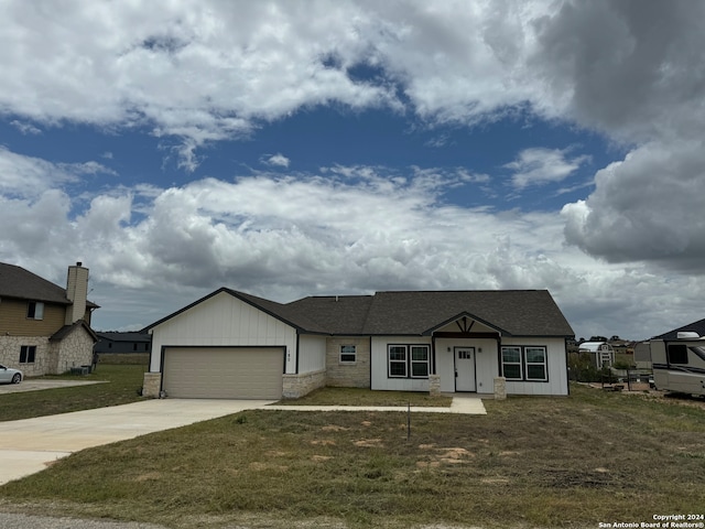 ranch-style house featuring a garage and a front yard