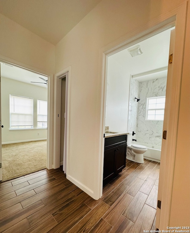 corridor featuring dark colored carpet and a wealth of natural light