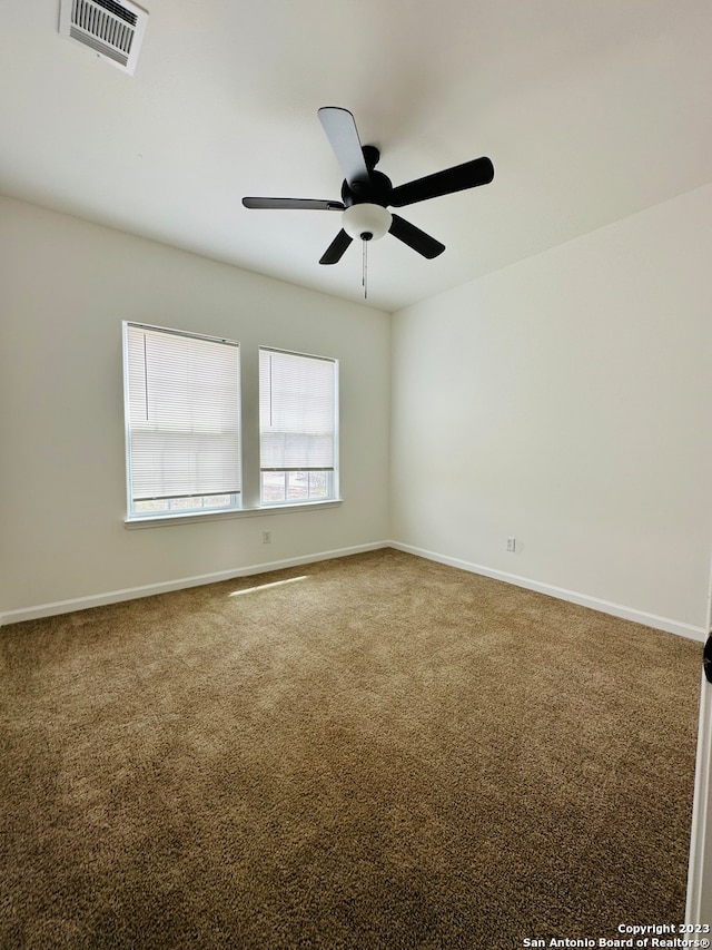 spare room featuring carpet flooring and ceiling fan