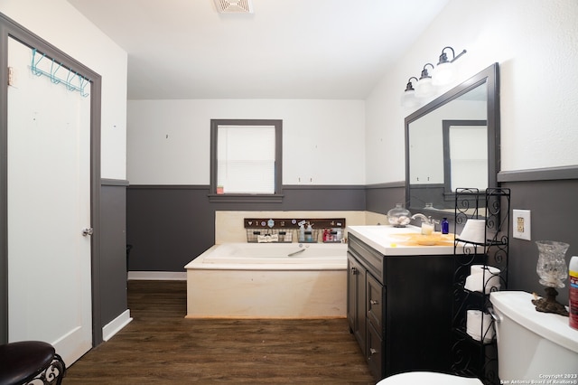 bathroom with hardwood / wood-style flooring, plenty of natural light, large vanity, and toilet