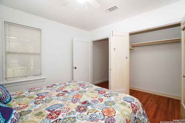 bedroom with a closet, dark wood-type flooring, and ceiling fan