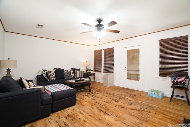 living room featuring light hardwood / wood-style floors, ceiling fan, and ornamental molding