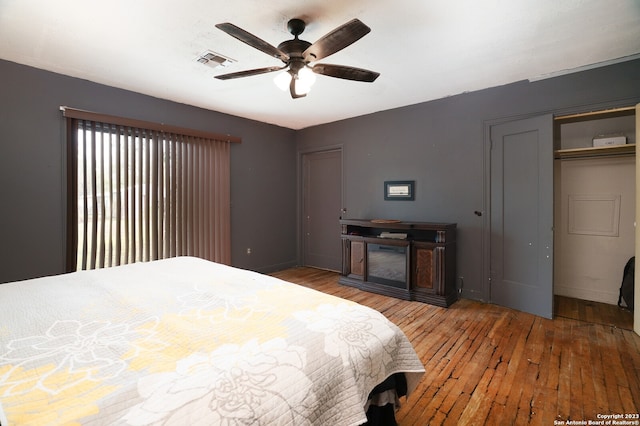 bedroom with ceiling fan, a closet, and light hardwood / wood-style flooring