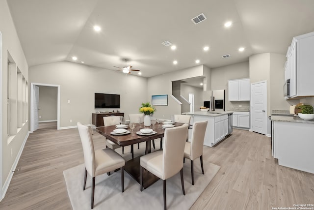 dining area with lofted ceiling, light wood-style flooring, recessed lighting, and visible vents