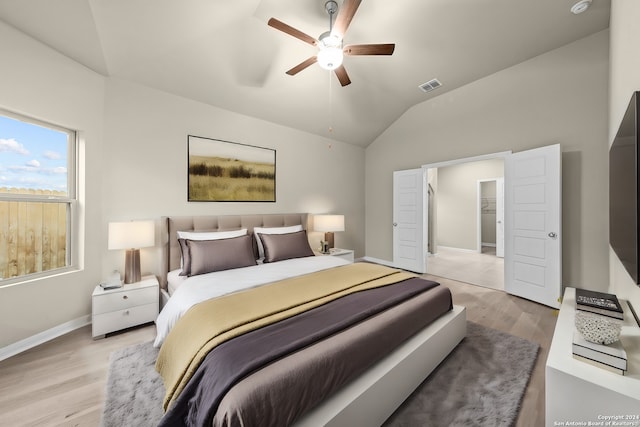 bedroom with light wood finished floors, visible vents, ceiling fan, baseboards, and lofted ceiling