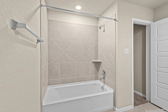 bathroom with baseboards, bathing tub / shower combination, and tile patterned flooring