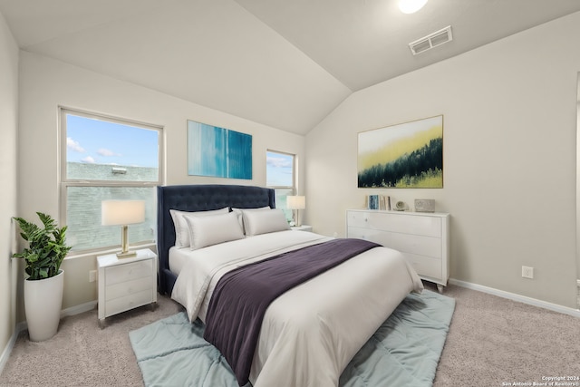 bedroom with visible vents, light carpet, multiple windows, and vaulted ceiling