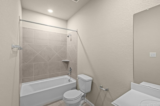 full bath with shower / washtub combination, toilet, and a textured wall