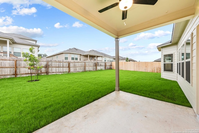 view of yard featuring a fenced backyard, a ceiling fan, and a patio area