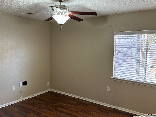 unfurnished room featuring ceiling fan, dark hardwood / wood-style floors, and a wealth of natural light