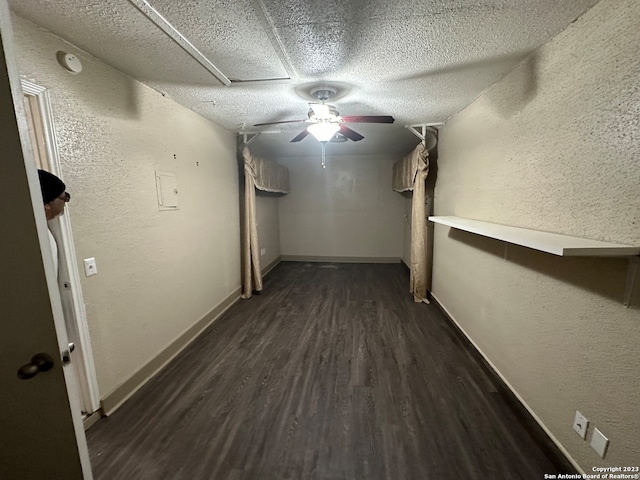 hallway featuring dark hardwood / wood-style flooring and a textured ceiling