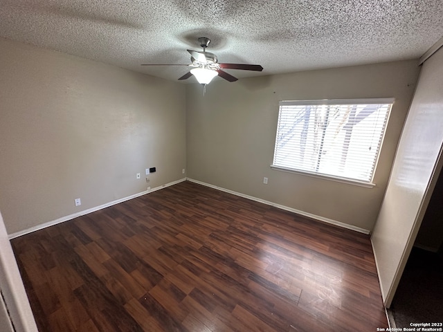 unfurnished room with a textured ceiling, ceiling fan, and dark wood-type flooring