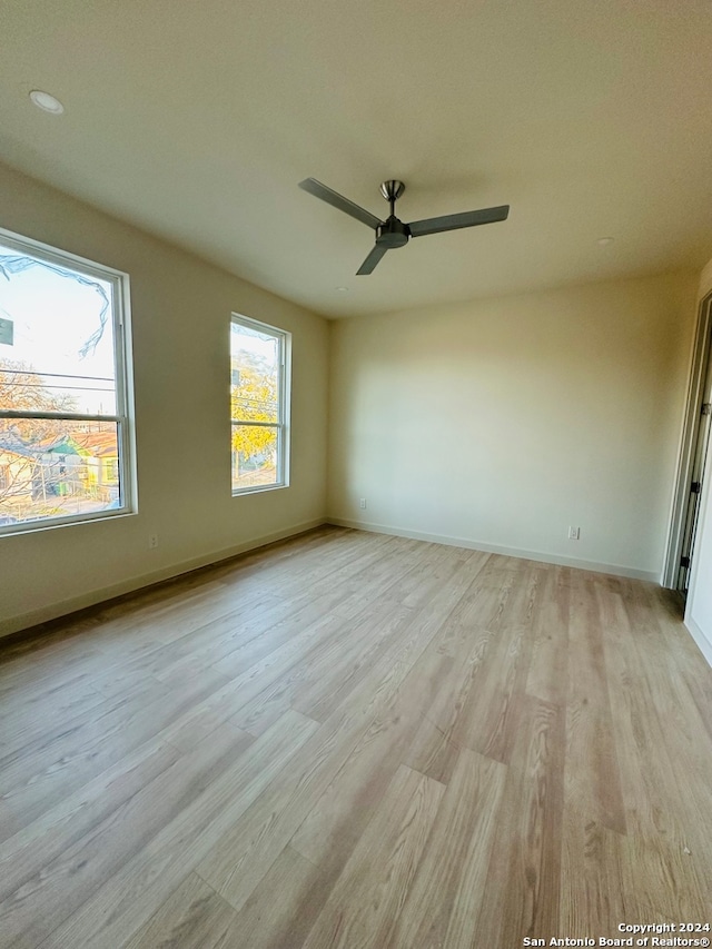 spare room featuring ceiling fan and light wood-type flooring