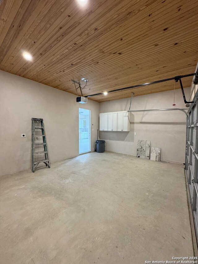 garage with wood ceiling and a garage door opener