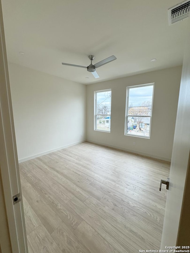 spare room featuring ceiling fan and light wood-type flooring