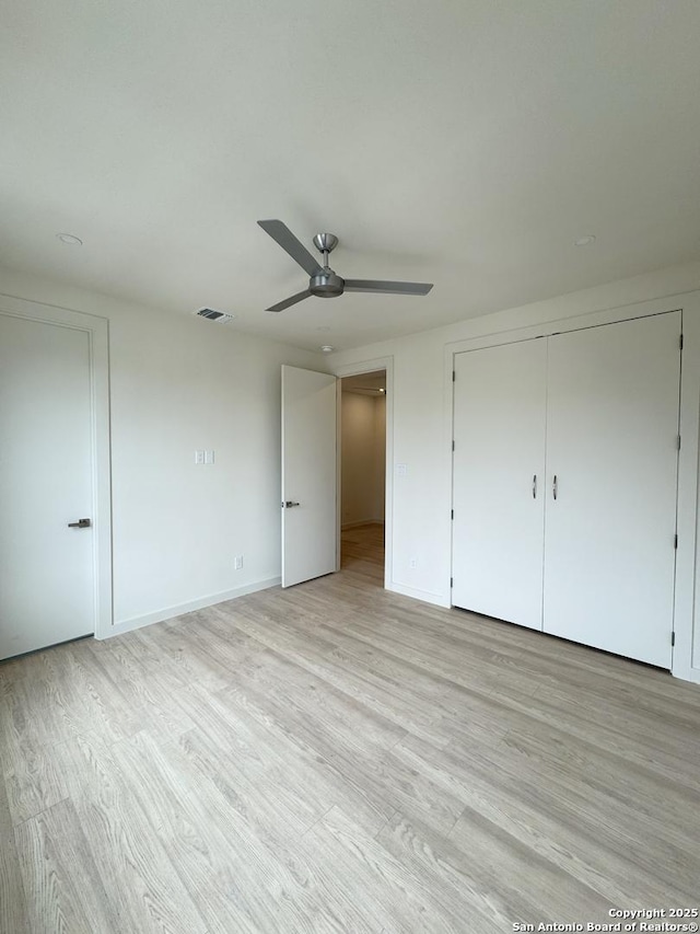 unfurnished bedroom with a closet, ceiling fan, and light hardwood / wood-style floors