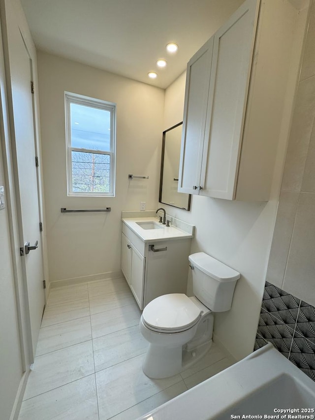 bathroom featuring toilet and vanity