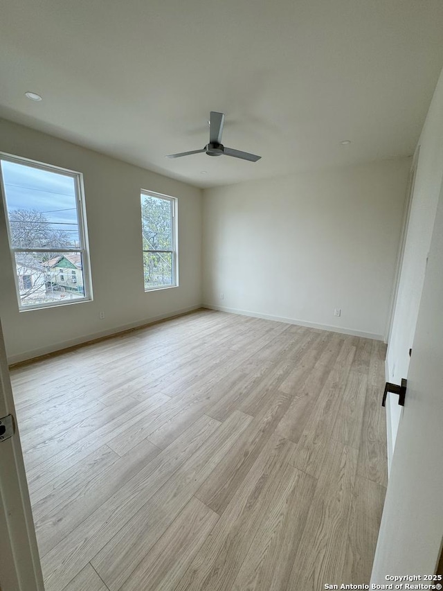 unfurnished room featuring ceiling fan and light hardwood / wood-style floors