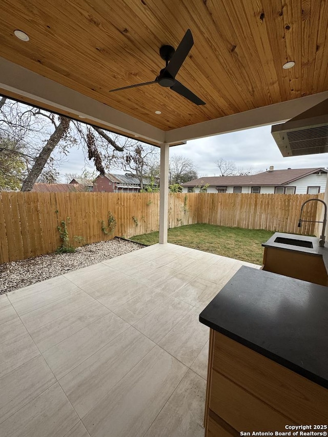 view of patio featuring ceiling fan