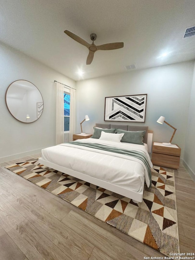 bedroom with ceiling fan and light hardwood / wood-style floors