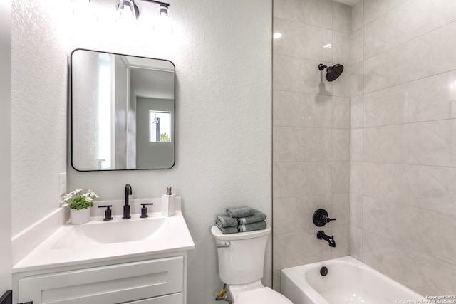 full bathroom with vanity, toilet, and tiled shower / bath