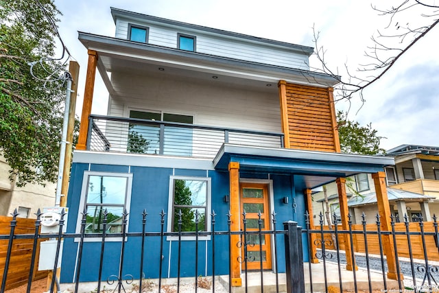 view of front of house with a balcony and a porch