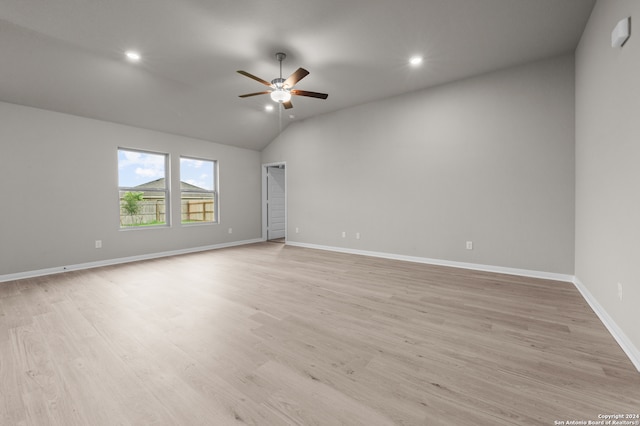 spare room with lofted ceiling, ceiling fan, and light hardwood / wood-style floors