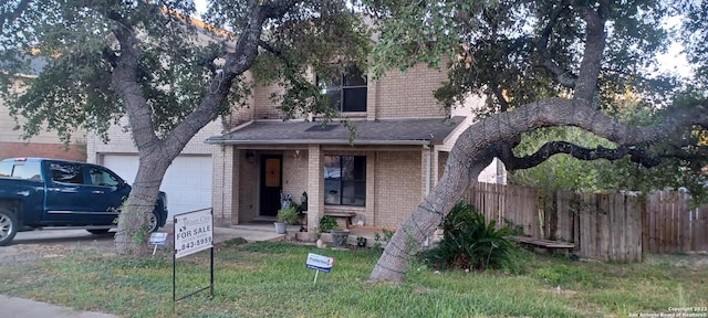 view of front of home featuring a front lawn and a garage