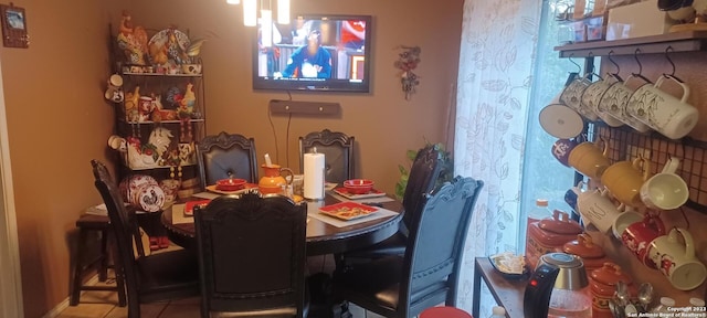 dining space featuring light tile floors