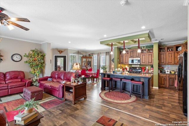 living room featuring a textured ceiling, crown molding, ceiling fan, and dark wood-type flooring