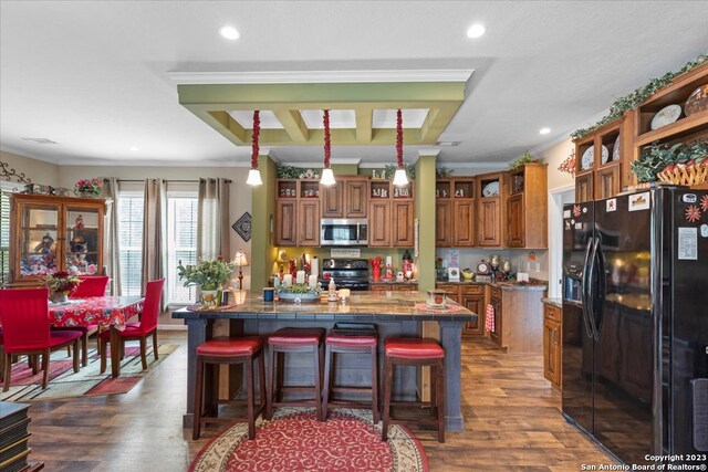 kitchen with ornamental molding, appliances with stainless steel finishes, open shelves, brown cabinetry, and dark wood finished floors