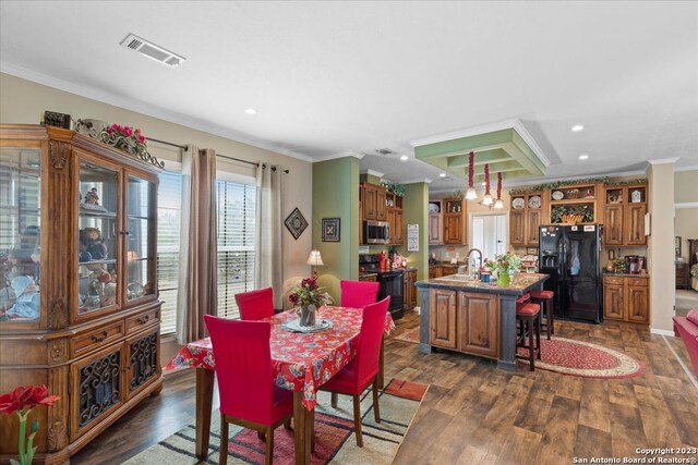 dining area featuring crown molding, visible vents, and dark wood-type flooring