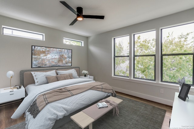 bedroom featuring ceiling fan and dark hardwood / wood-style flooring