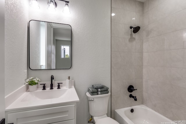 full bathroom featuring vanity, toilet, and tiled shower / bath