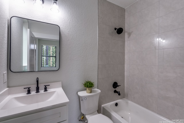 full bathroom with tiled shower / bath, toilet, and vanity