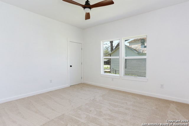 carpeted empty room with ceiling fan