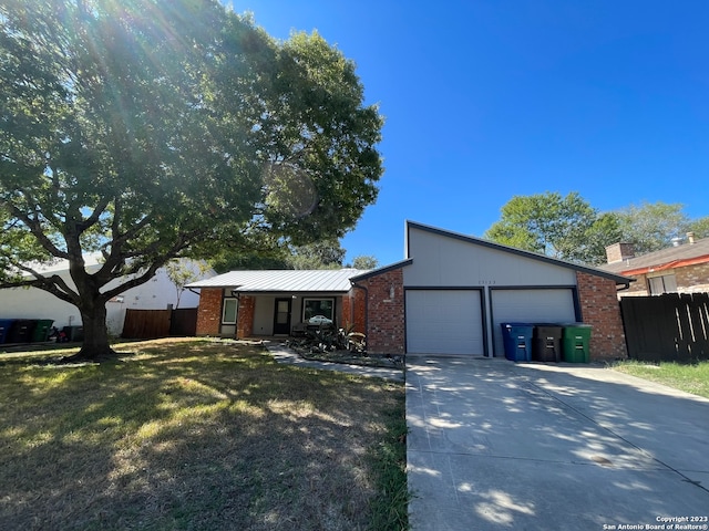 single story home featuring a garage and a front yard