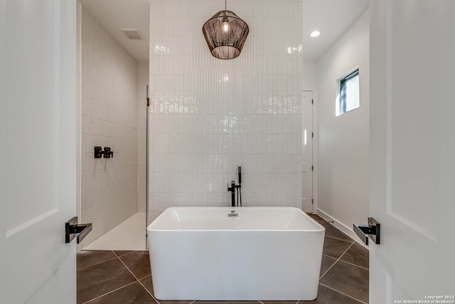 bathroom with tile walls and tile flooring