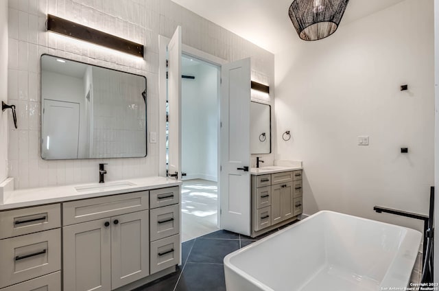 bathroom with tile walls, tile flooring, and large vanity