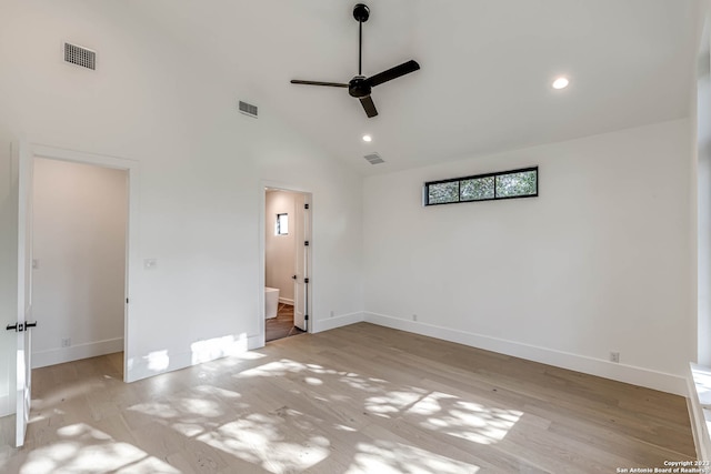 unfurnished bedroom featuring ceiling fan, high vaulted ceiling, ensuite bathroom, and light hardwood / wood-style floors