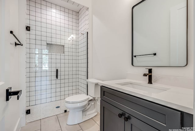 bathroom featuring walk in shower, tile flooring, large vanity, and toilet