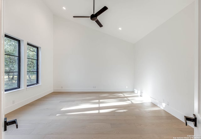 unfurnished room featuring light hardwood / wood-style flooring, ceiling fan, and high vaulted ceiling