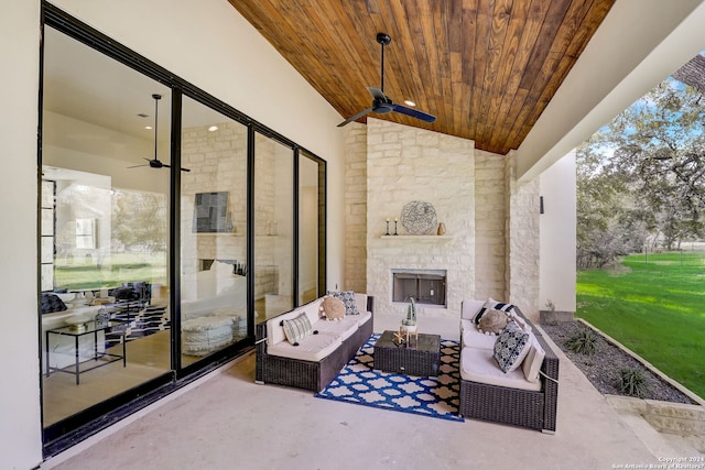 view of terrace with ceiling fan and an outdoor living space with a fireplace