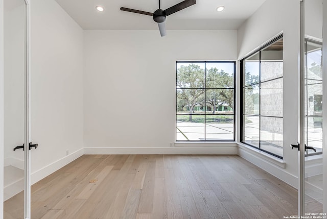 unfurnished room featuring french doors, ceiling fan, and light hardwood / wood-style flooring