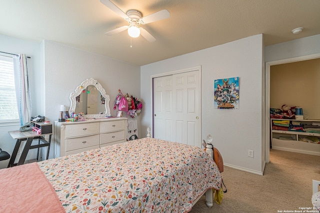 bedroom featuring a closet, ceiling fan, and light colored carpet