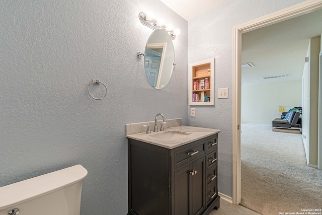 bathroom featuring toilet and large vanity