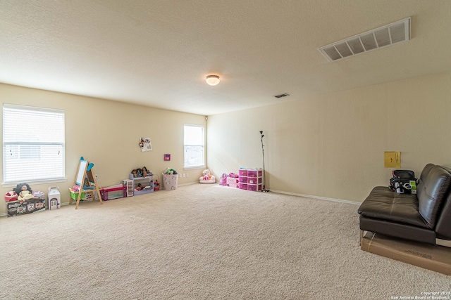 rec room with a textured ceiling and carpet floors