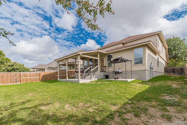 back of property with a lawn and a patio