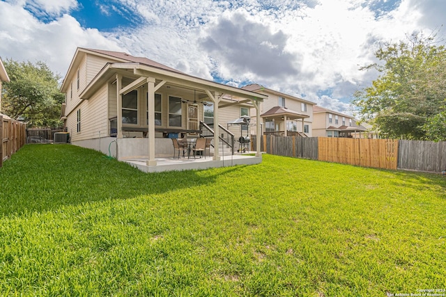 back of house featuring a yard, a patio, and central AC unit